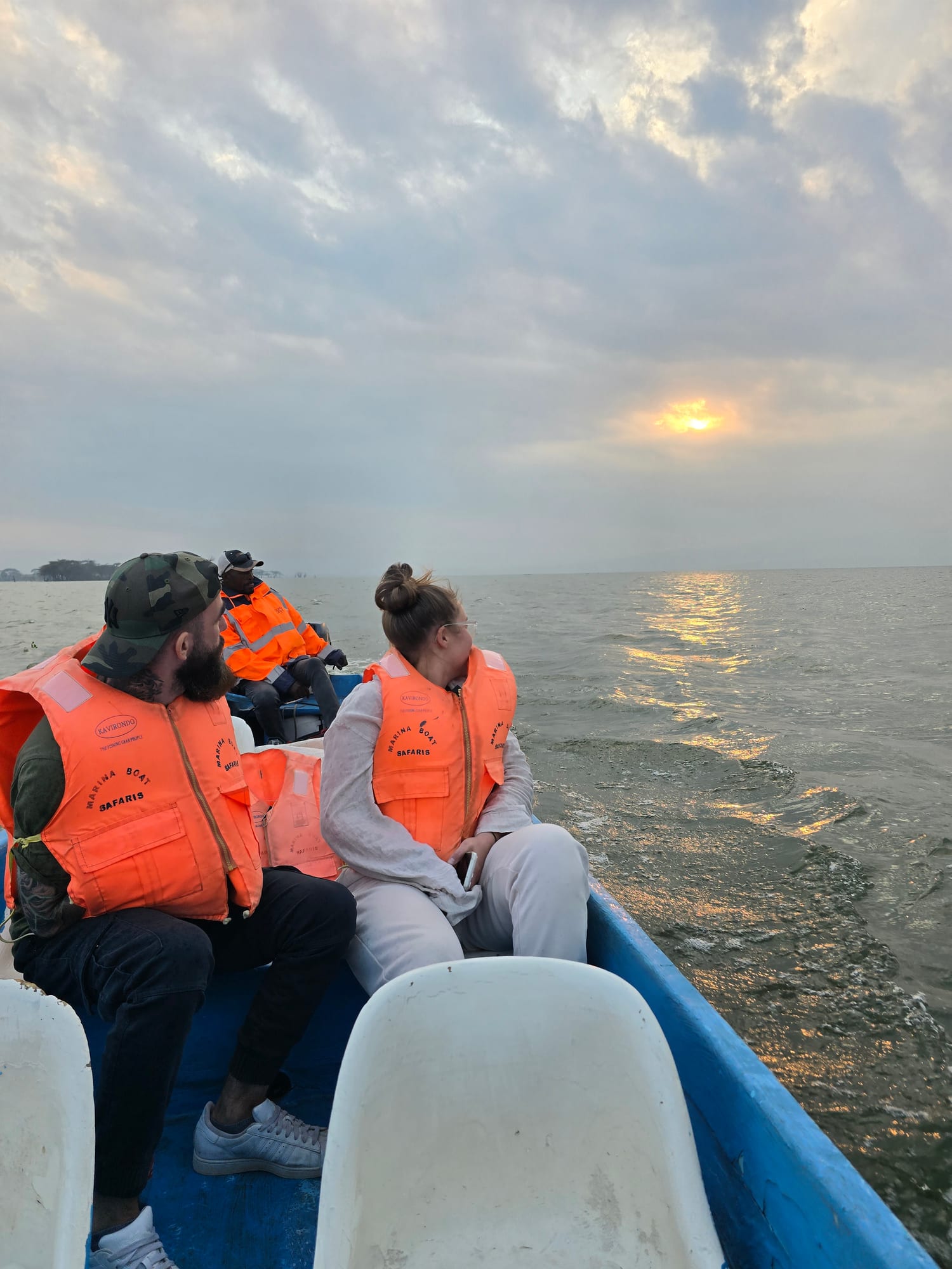 Guests on a boat safari at sunset
