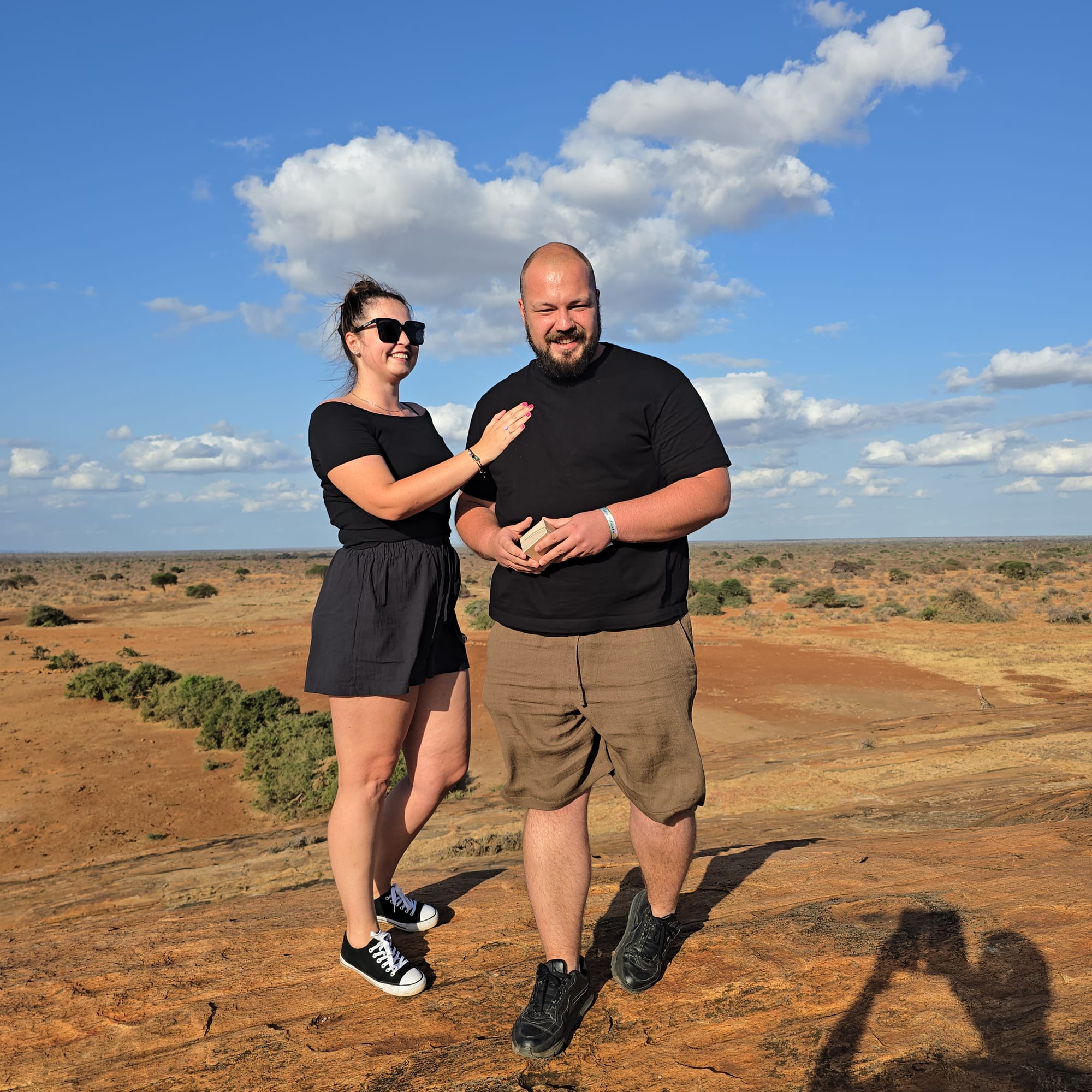 Guests at a rocky viewpoint over the plains