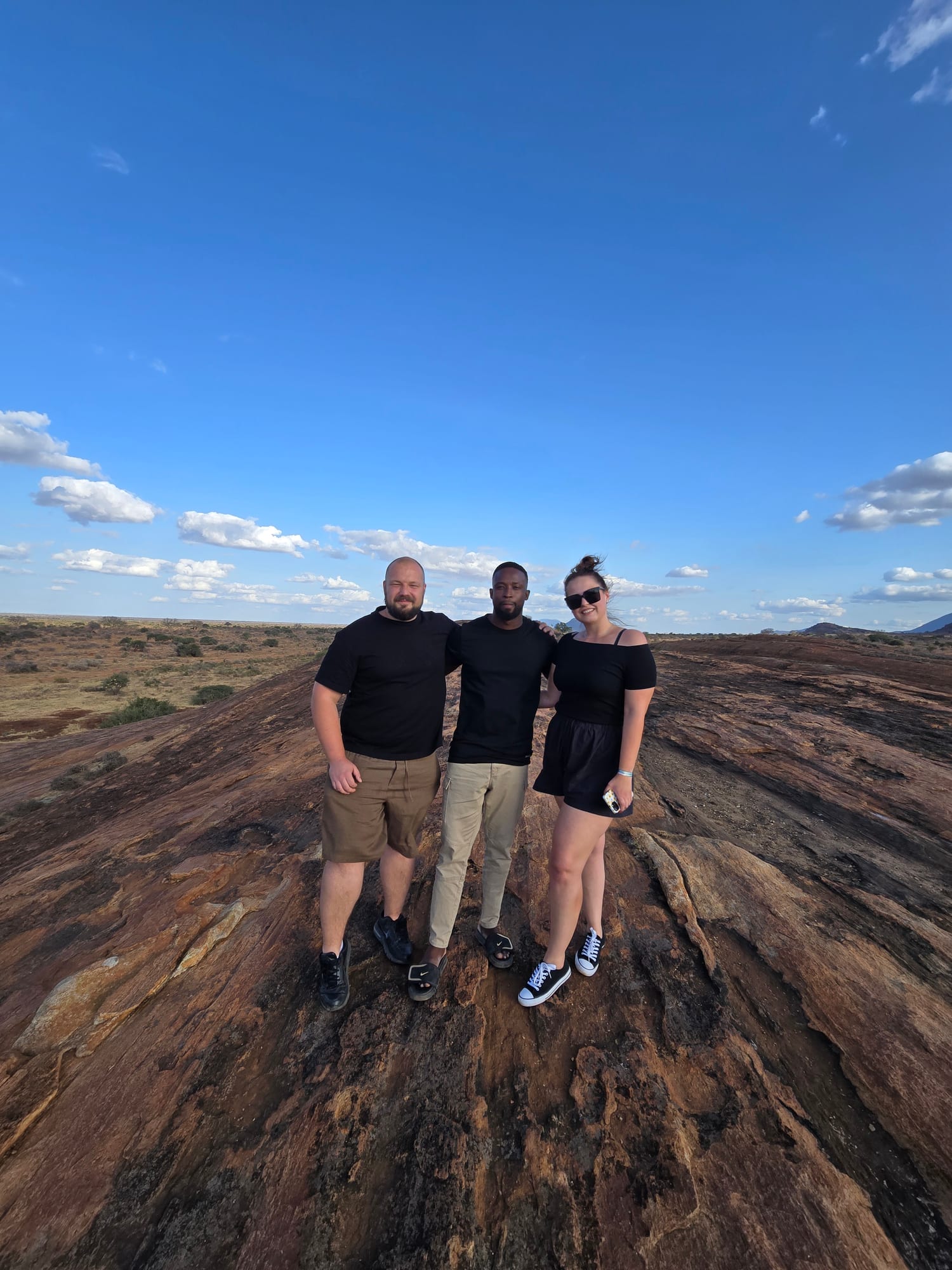 Group at a rocky viewpoint over the plains