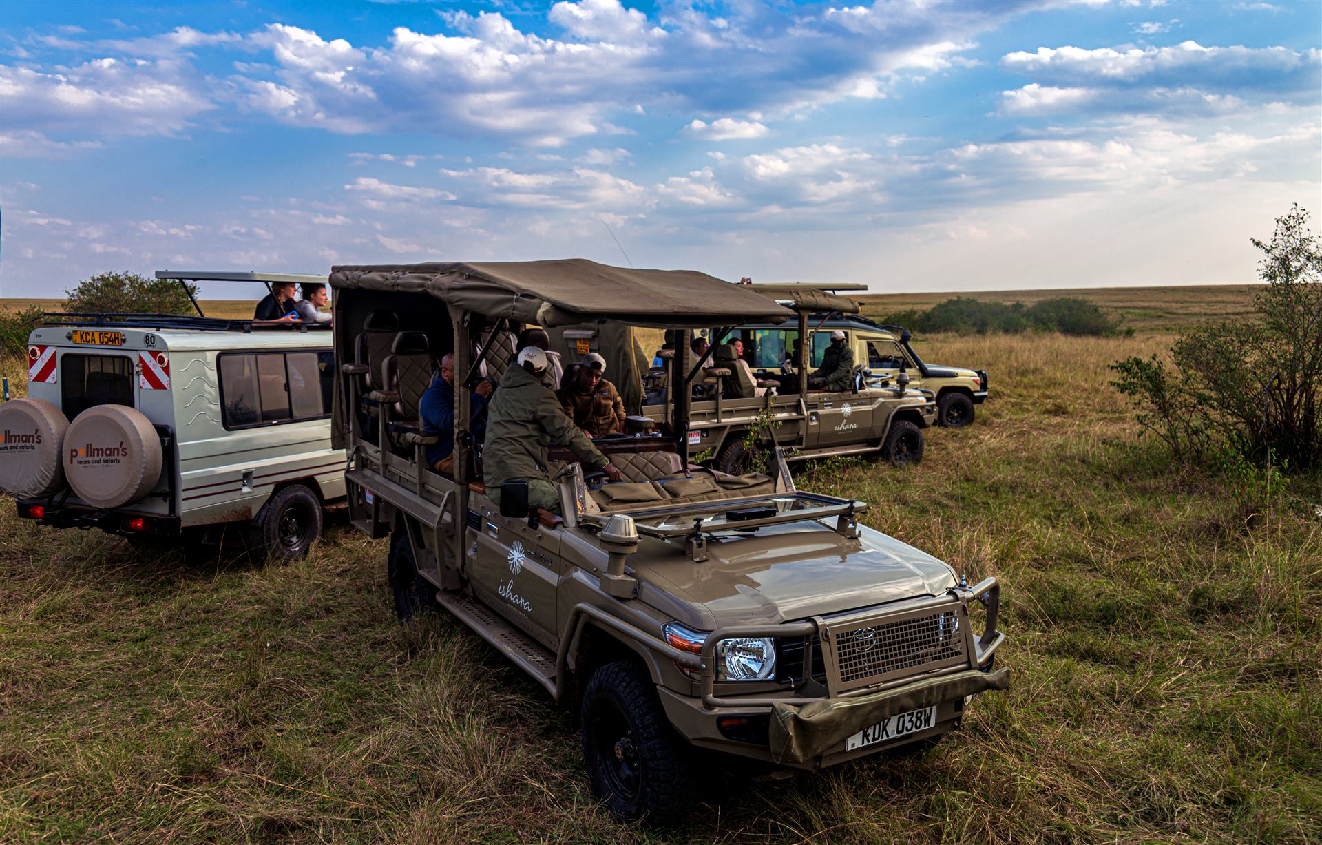 Convoy of safari jeeps on a dirt road